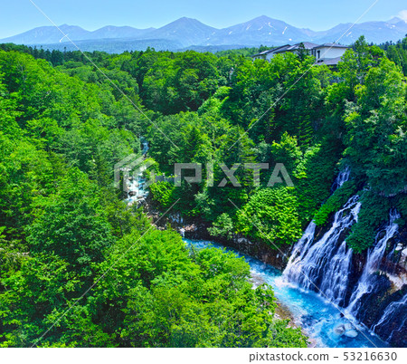 Shirasagi Falls and Tokachidake Mountain Range in Biei-cho, Hokkaido in early summer 53216630