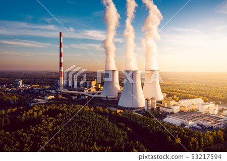 A Power plant with white smoke over it's chimneys A Power plant with white smoke over it's chimneys 53217594