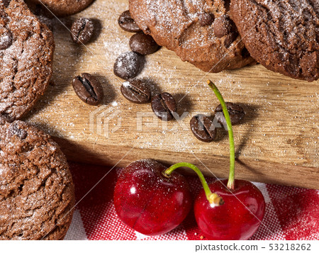 Oatmeal chocolate cookies with coffee grains and cherry. Sun flare Oatmeal chocolate cookies with coffee grains and cherry. Sun flare 53218262