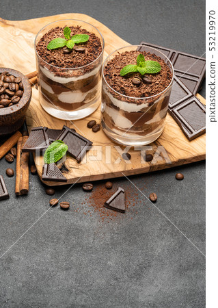 Classic tiramisu dessert in a glass on dark concrete background Classic tiramisu dessert in a glass on dark concrete background 53219970