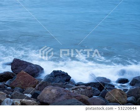beautiful silky smooth water waves and rocks on t 53220644