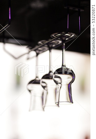 Glasses for a grappa hang over a bar counter Glasses for a grappa hang over a bar counter 53220871