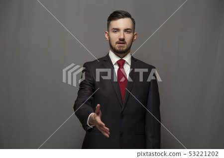 Businessman posing with hand aiming at the camera 53221202