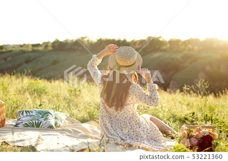 Happy woman lifestyle, beautiful relaxed girl in a straw hat on the nature from the back on picnic - Happy woman lifestyle, beautiful relaxed girl in a straw hat on the nature from the back on picnic - 53221360