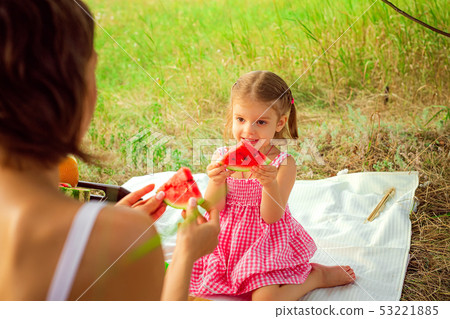 Funny portrait of an incredibly beautiful little girl eating watermelon, healthy fruit snack 53221885