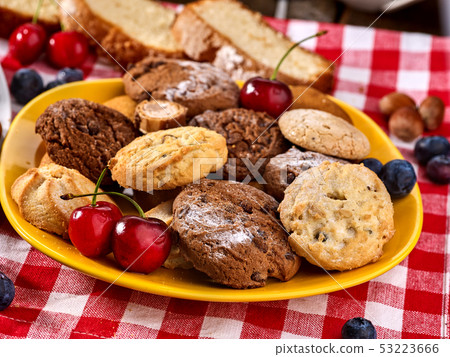 Chocolate oatmeal cookies and sand heart shape cake with blueberries 53223666