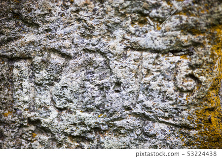 Moss-grown surface of the old stone cross 53224438