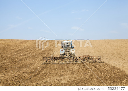 Harrowing the soil with tine harrows 53224477