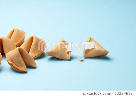 Chinese fortune cookies. Cookies with empty blank inside for prediction words. Blue background. Chinese fortune cookies. Cookies with empty blank inside for prediction words. Blue background. 53224652