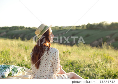 Happy Woman Life Style, beautiful relaxed girl in a straw hat on the nature picnic basket flowers in Happy Woman Life Style, beautiful relaxed girl in a straw hat on the nature picnic basket flowers in 53224732
