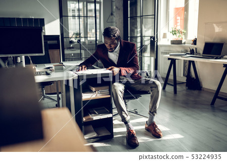 Businessman wearing striped socks feeling busy while working 53224935