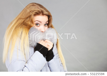 Woman wearing winter warm furry jacket Woman wearing winter warm furry jacket 53225594