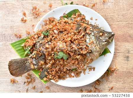 batter fried mango fish topping chop garlic  53227438