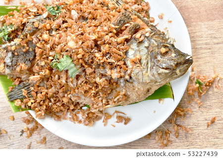 batter fried mango fish topping chop garlic  53227439