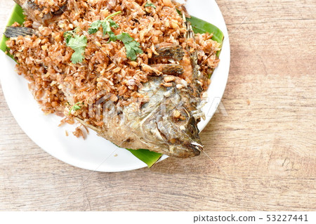 batter fried mango fish topping chop garlic  53227441