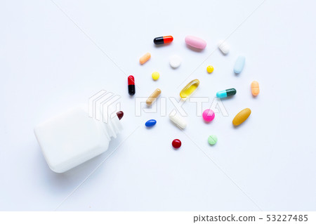 Colorful tablets with capsules and pills on white. Colorful tablets with capsules and pills on white. 53227485