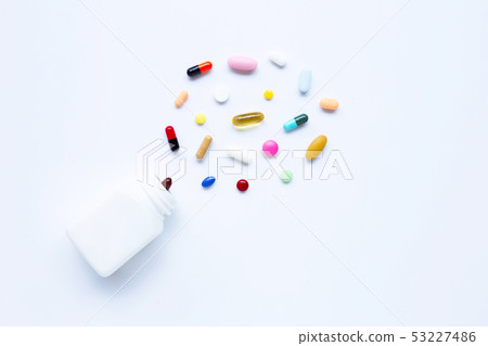 Colorful tablets with capsules and pills on white. Colorful tablets with capsules and pills on white. 53227486