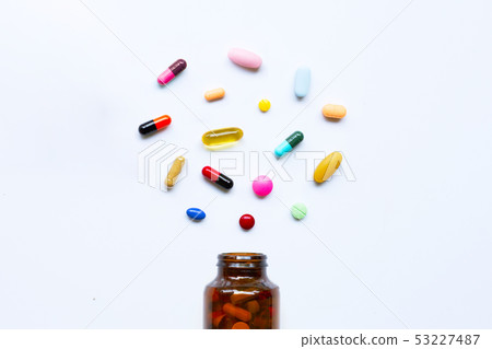 Colorful tablets with capsules and pills on white. Colorful tablets with capsules and pills on white. 53227487
