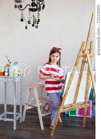 Little artist girl holding a paintbrush and 53228005