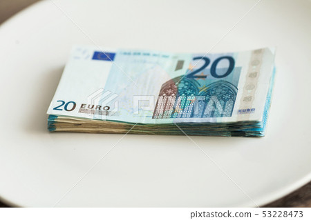 Money lying on the plate. Euros photo. Greedy corruption concept. Bribe idea. 53228473