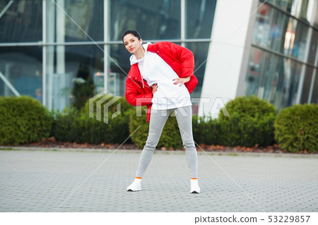 Fitness girl. Young sports woman stretching in the modern city. Healthy lifestyle in the big city Fitness girl. Young sports woman stretching in the modern city. Healthy lifestyle in the big city 53229857