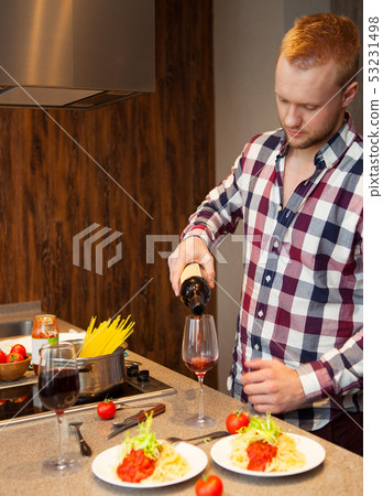 Handsome man cooking at home preparing pasta 53231498