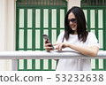 Beautiful smile Asia sunglass girl lady use mobile 53232638