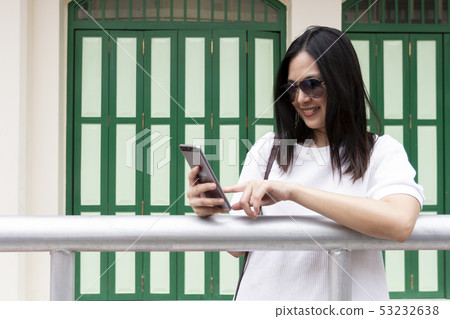 Beautiful smile Asia sunglass girl lady use mobile 53232638