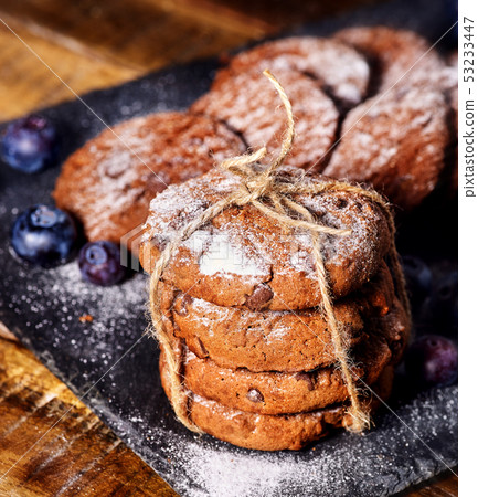 Chocolate chip cookies tied with string. Serving food on slate Chocolate chip cookies tied with string. Serving food on slate 53233447