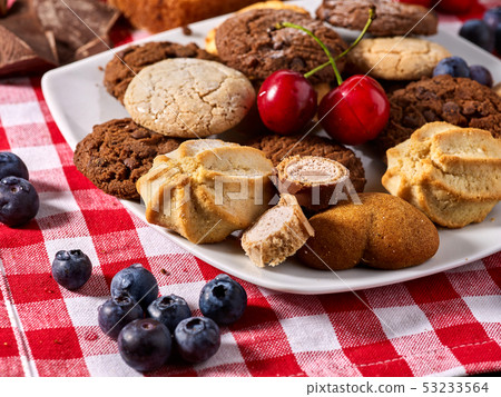 Oatmeal Cookies and sand chocolate cake with nut on table 53233564