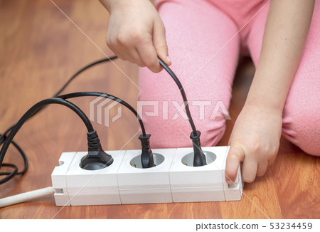 Little child playing with plug Little child playing with plug 53234459
