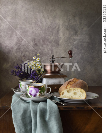 Retro still life poster breakfast. Vintage coffee grinder cups, silver spoon, homemade bread bakery 53235152