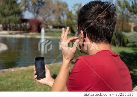 Young boy communicating with sign language Young boy communicating with sign language 53235185