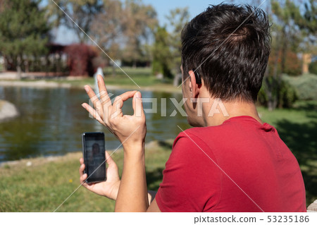 Young boy communicating with sign language Young boy communicating with sign language 53235186