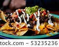 Beef and cheese corn nachos served on a big plate 53235236