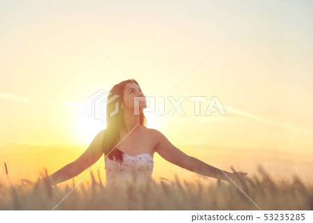 Young woman looking up into the sky. Young woman looking up into the sky. 53235285