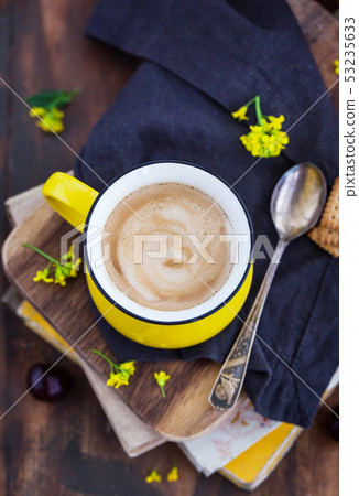 Bright yellow mug of fresh hot black coffee Bright yellow mug of fresh hot black coffee 53235633