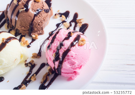 Ice cream with walnuts and chocolate topping Ice cream with walnuts and chocolate topping 53235772