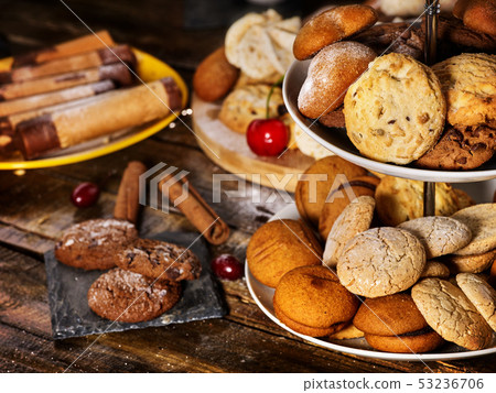 Oatmeal cookies, crispy wafer rolls on tier cake stand Oatmeal cookies, crispy wafer rolls on tier cake stand 53236706