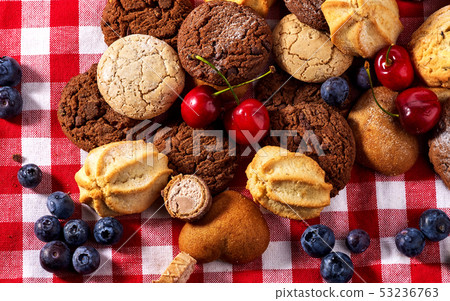 Cookies and sand biscuit on tier cake stand with blueberry chocolate 53236763