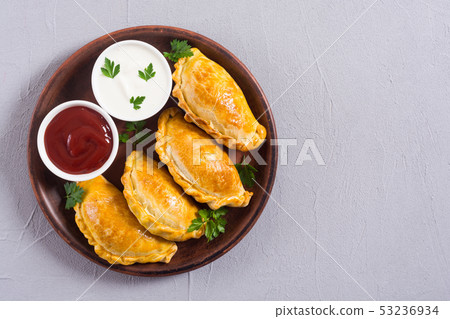 Latin American baked beef empanadas with sauce Latin American baked beef empanadas with sauce 53236934