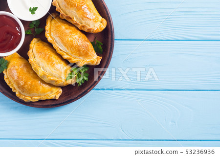 Latin American baked beef empanadas with sauce 53236936
