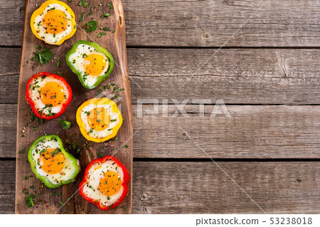 Yellow , red and green pepper with fried eggs Yellow , red and green pepper with fried eggs 53238018