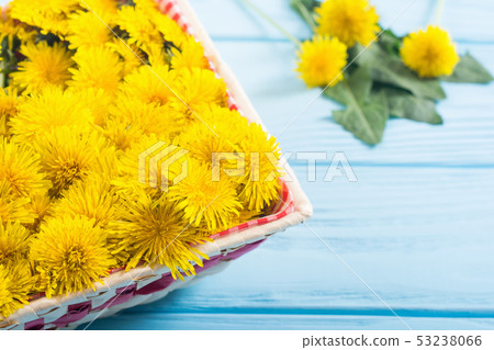 Basket with yellow dandelion flower 53238066