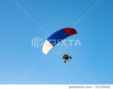 Powered parachute against the blue sky. Powered parachute against the blue sky. 53238082