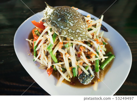 Spicy papaya salad with raw blue crab on the table Spicy papaya salad with raw blue crab on the table 53249497