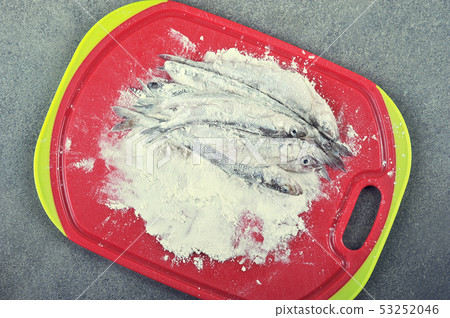 fish smelt rolled in flour and ready for frying on fish smelt rolled in flour and ready for frying on 53252046