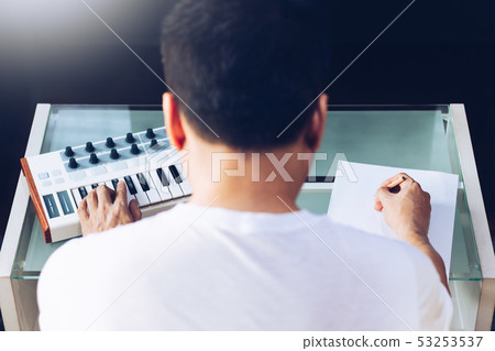 back of asian male songwriter writing a song back of asian male songwriter writing a song 53253537