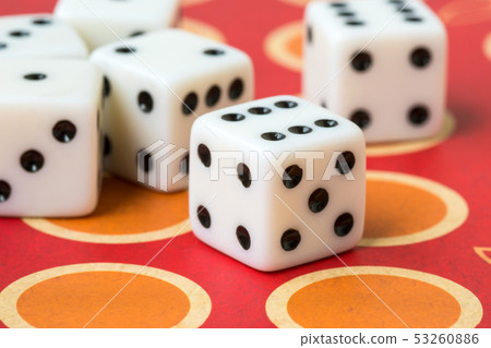 Several white dice on board game 53260886