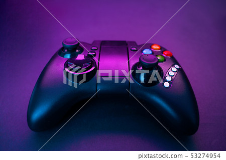 Gamepad on violet table background. Gamepad on violet table background. 53274954